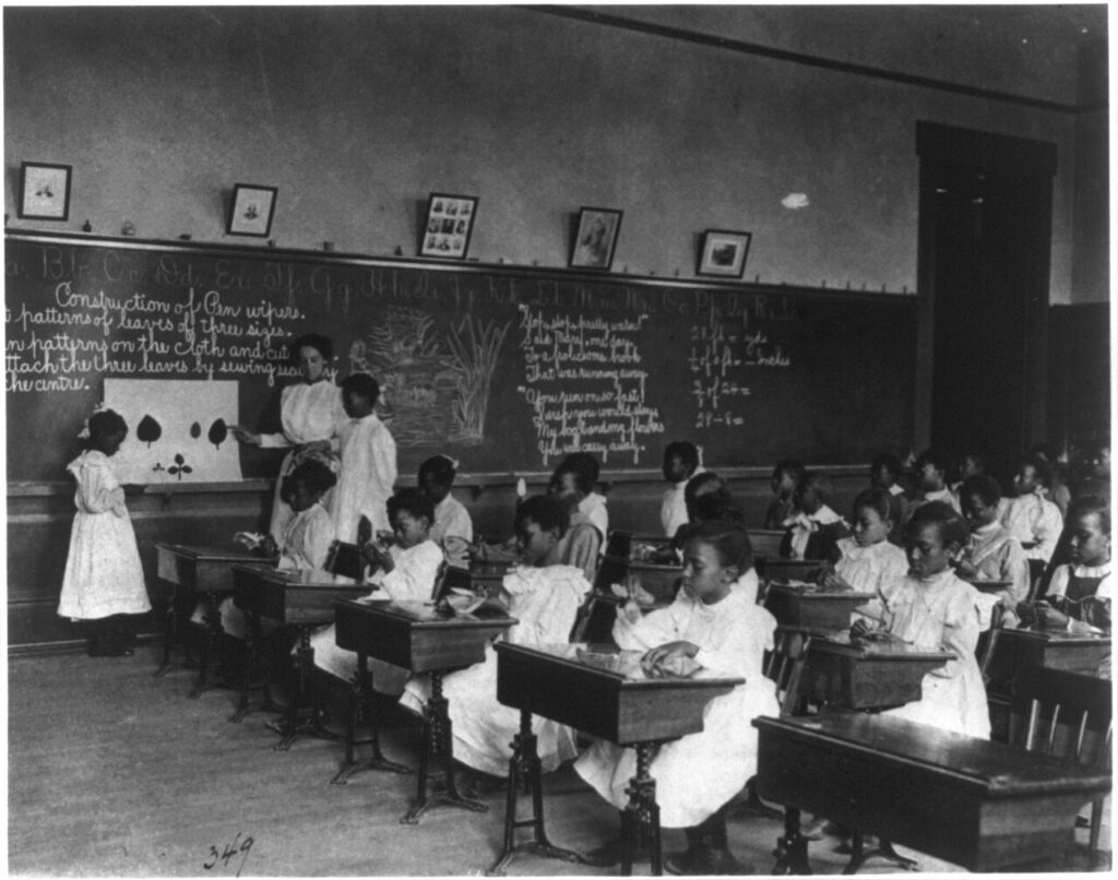 African American schoolgirls in classroom, learning to sew LCCN2001699118