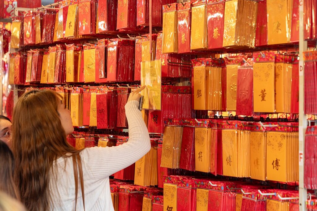 Children selecting red envelopes for Chinese New Year in Singapore
