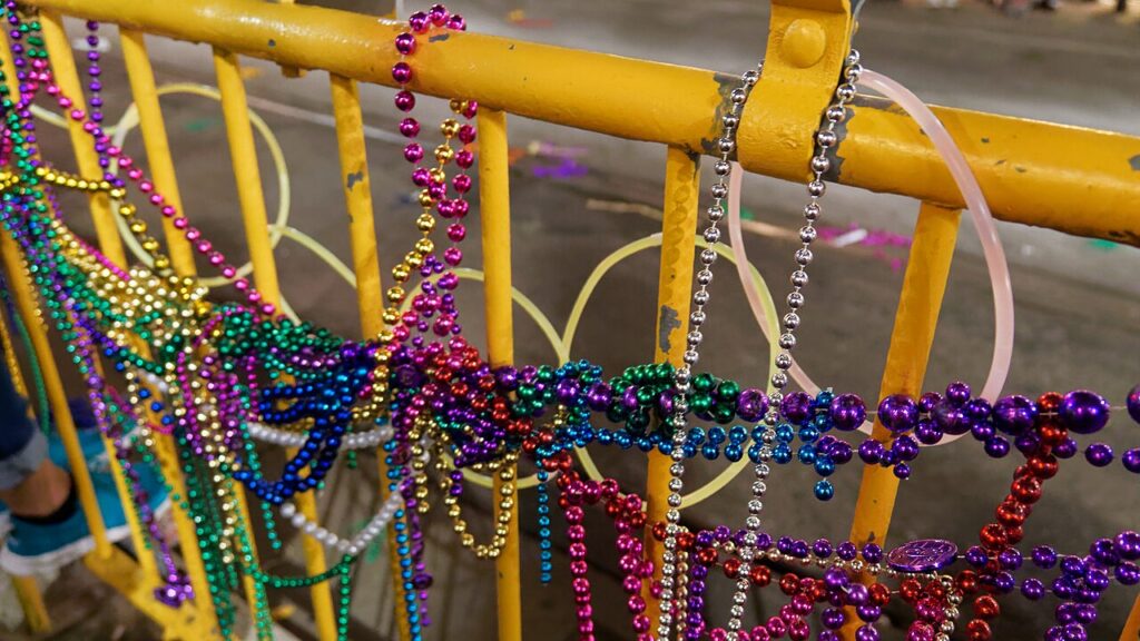 Mardi Gras Beads on a Metal Blockade Gate