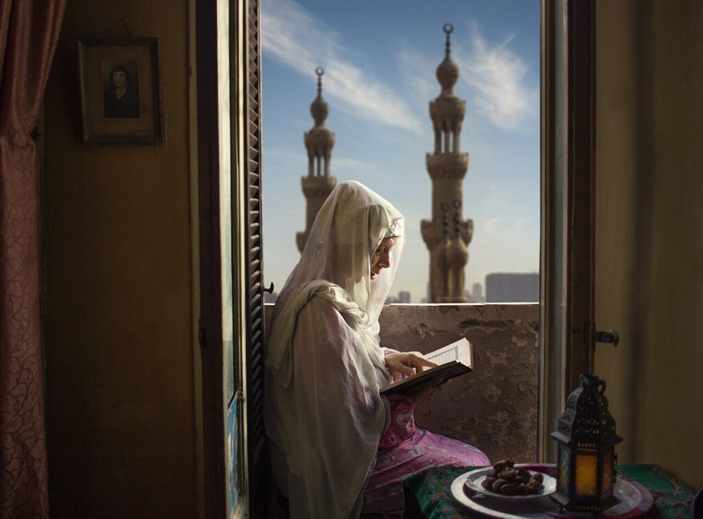 A woman reading the Quran during Ramadan