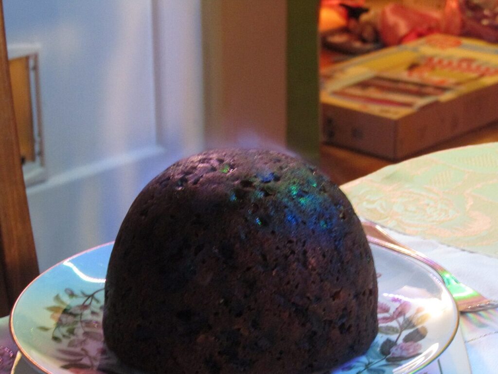 A Christmas pudding being flamed