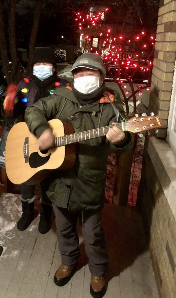 Carol singers at a doorway