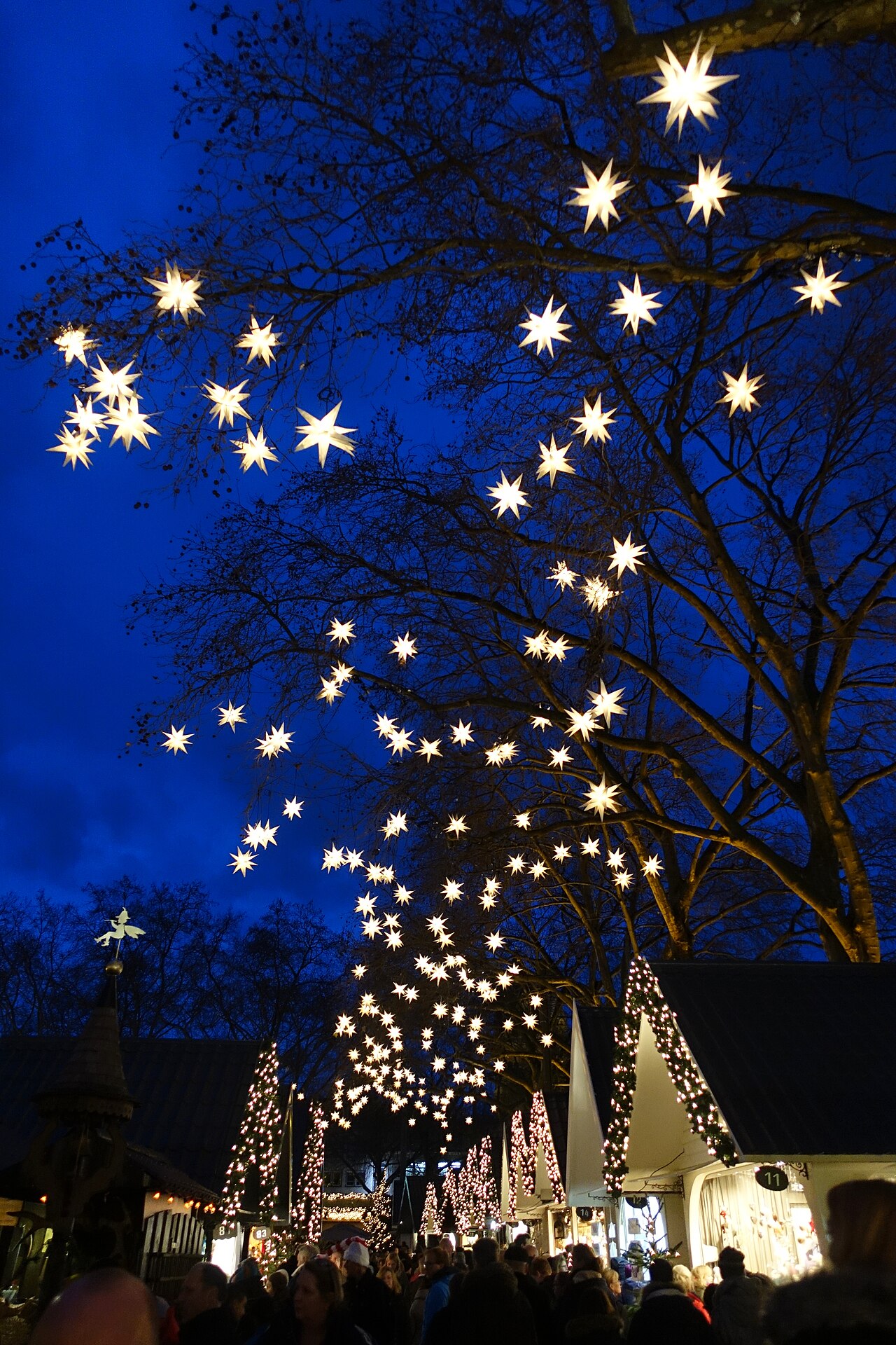 A German Christmas market in Cologne lit up at night