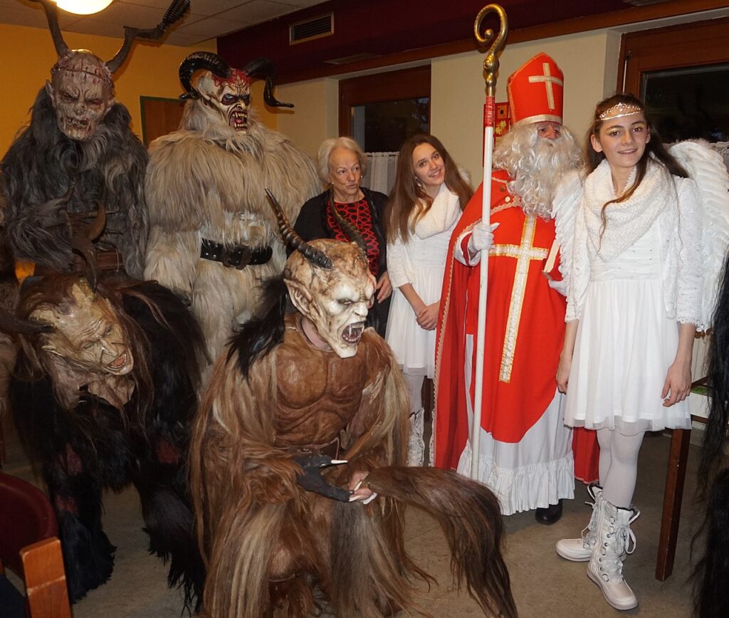 Saint Nicholas with Krampus and angels
