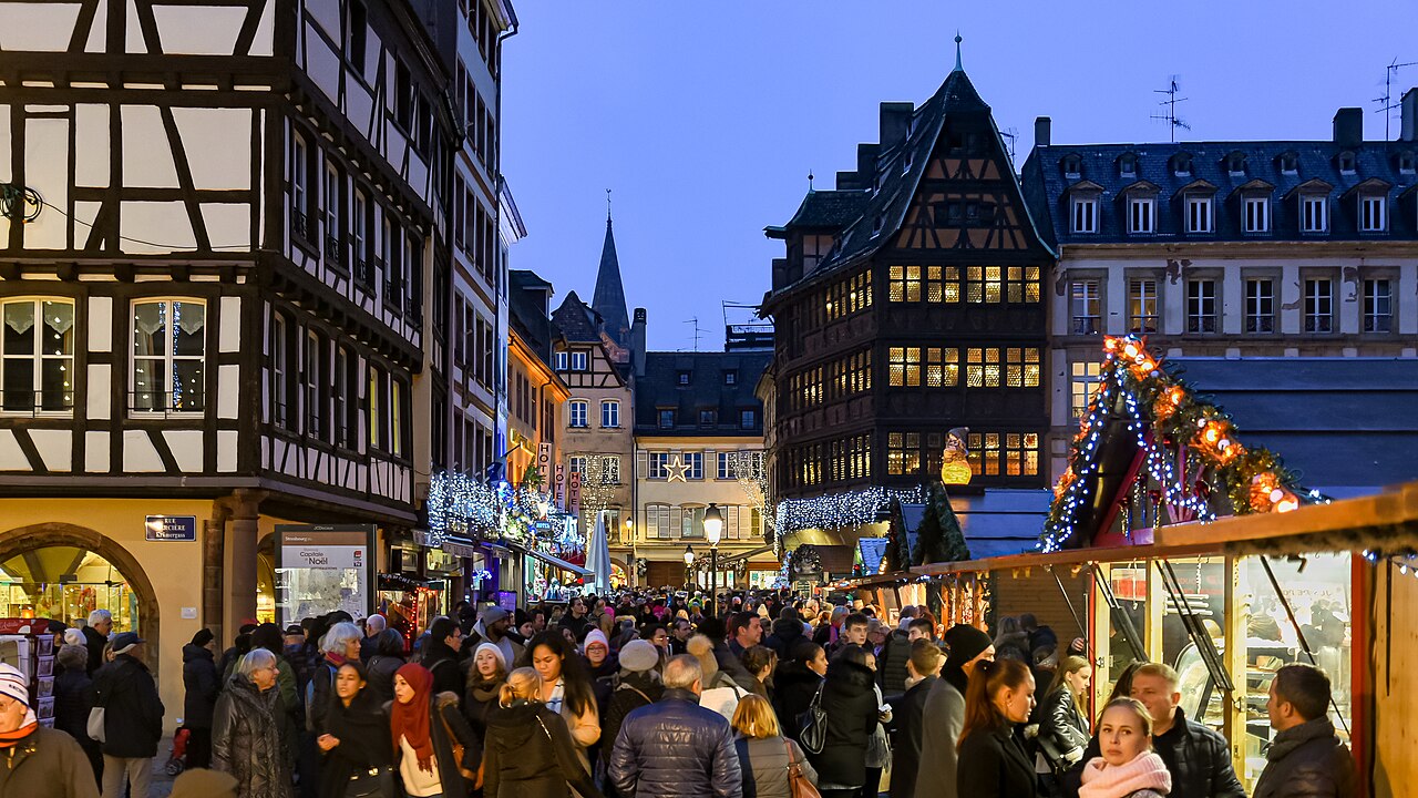 Stalls and lights at the Strasbourg Christmas market in France at dusk